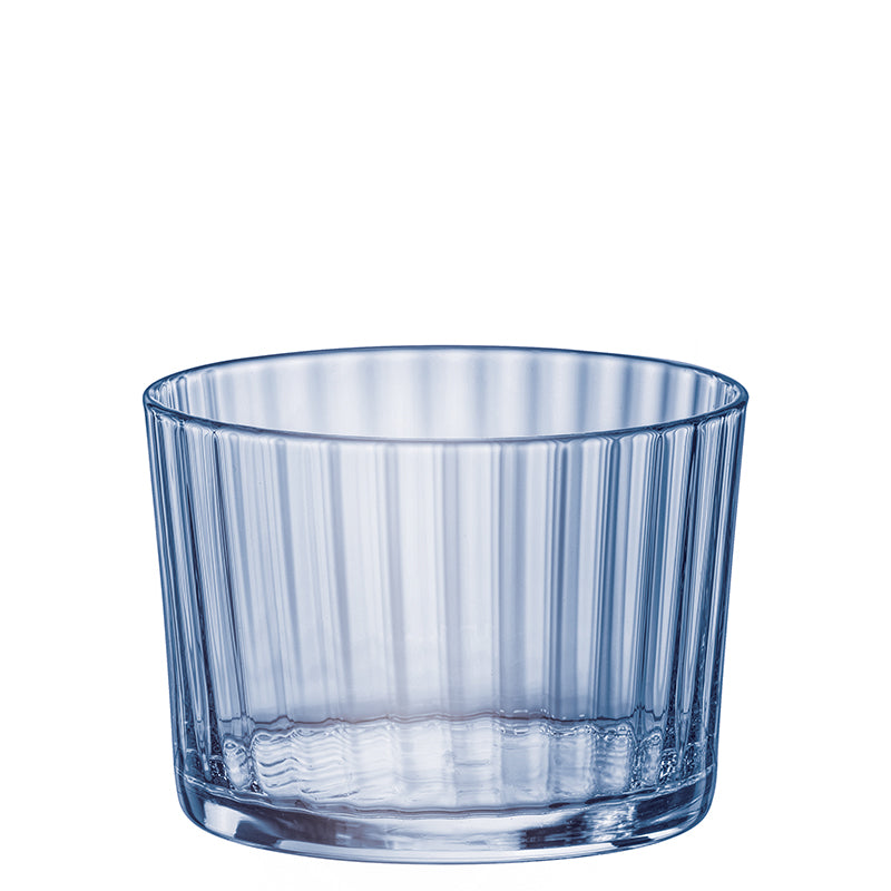 Verre transparent en verre avec surfaces verticales cannelées, fond épais et forme cylindrique légèrement conique.