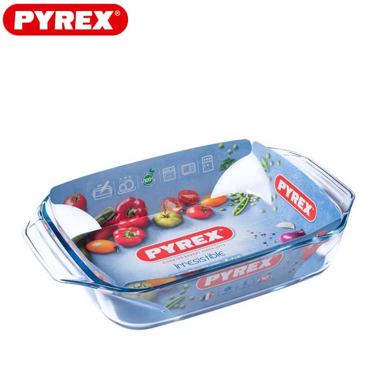 Plat à four rectangulaire en verre transparent avec poignées latérales et étiquette Pyrex avec images de légumes et informations d'utilisation