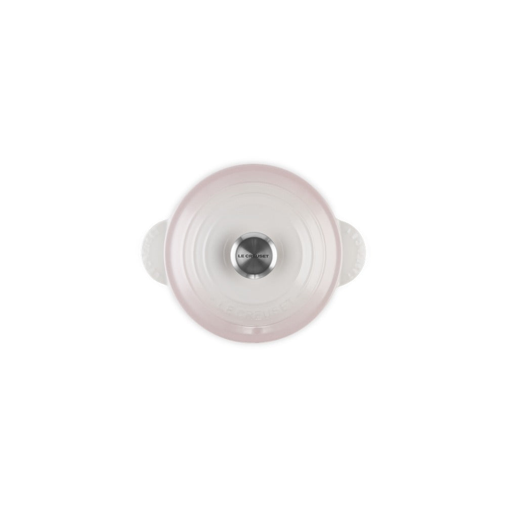 Couvercle en céramique blanc et rose avec poignées, doté d'une poignée centrale en acier inoxydable.