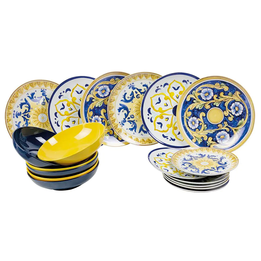 Set di piatti decorati in blu e giallo, con alcuni ciotole nere e gialle disposte in modo ordinato.