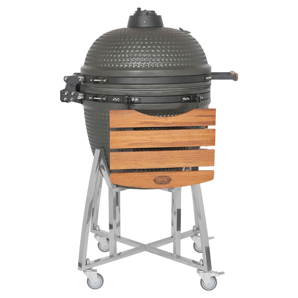 Runder grauer Vertikalgrill mit strukturierter Oberfläche, Stahlgestell mit Rädern, Holzablage und schwarzem Griff.