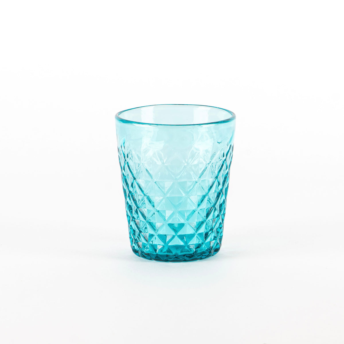 Verre turquoise en verre transparent avec surface givré et décoration à motif géométrique sur fond blanc