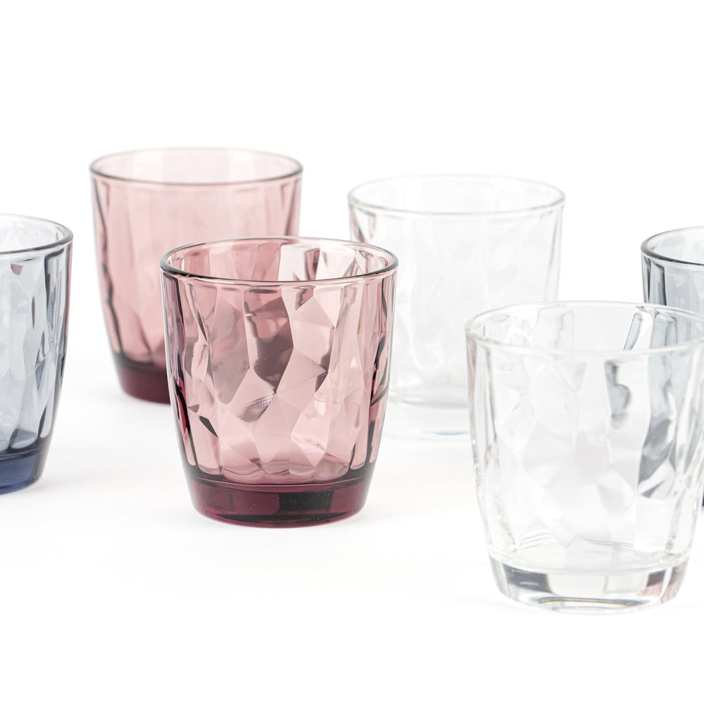 Set di sei bicchieri in vetro, nei colori rosa, trasparente e blu scuro, con superficie ondulata.
