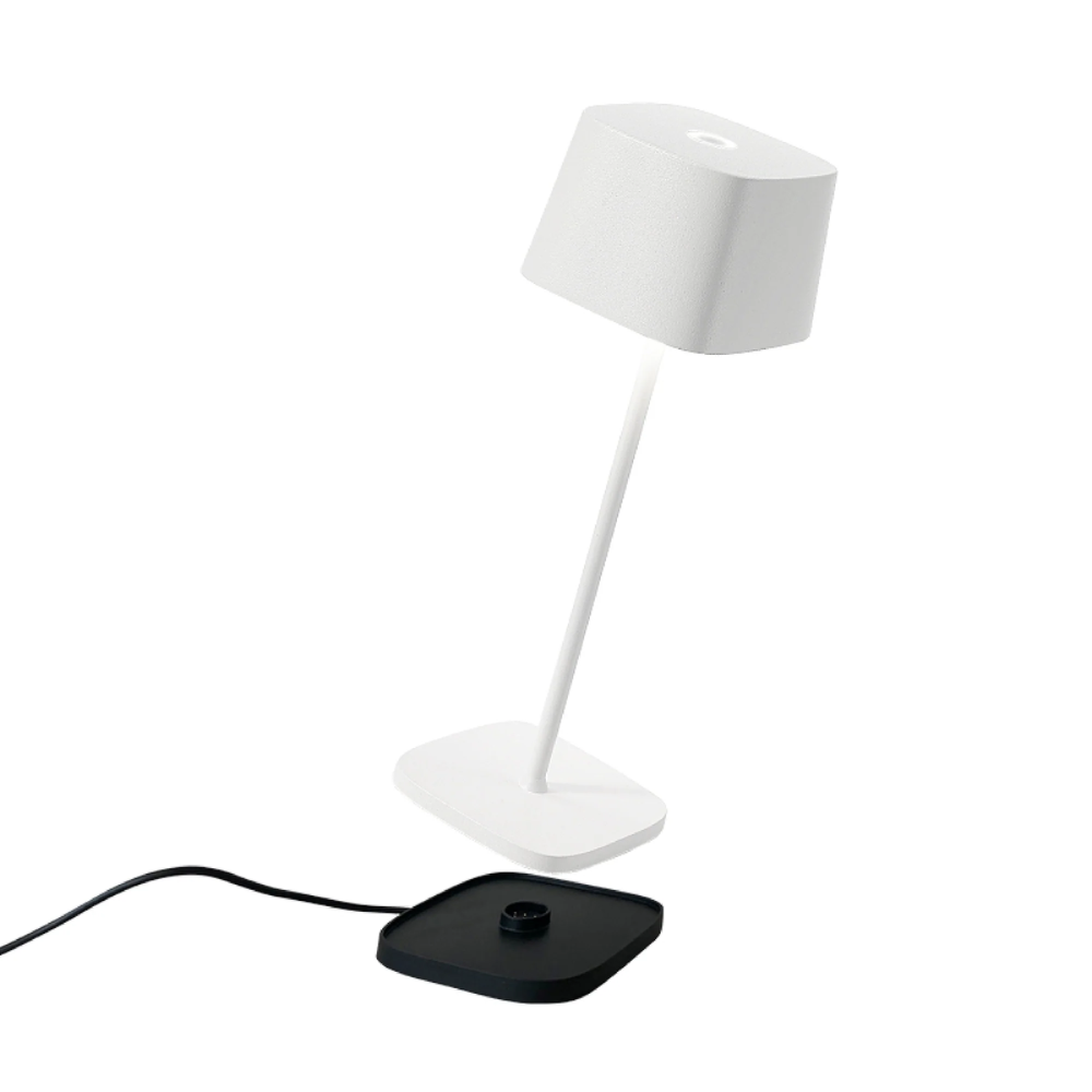 Weiße Tischlampe mit abgesetzter schwarzer Basis auf weißem Hintergrund, modernes Design und klare Linien.