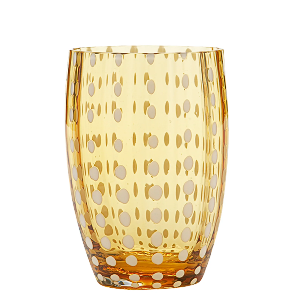Verre transparent en verre jaune avec white polka dot patterns distribuiti uniformemente, fsurd blanc.