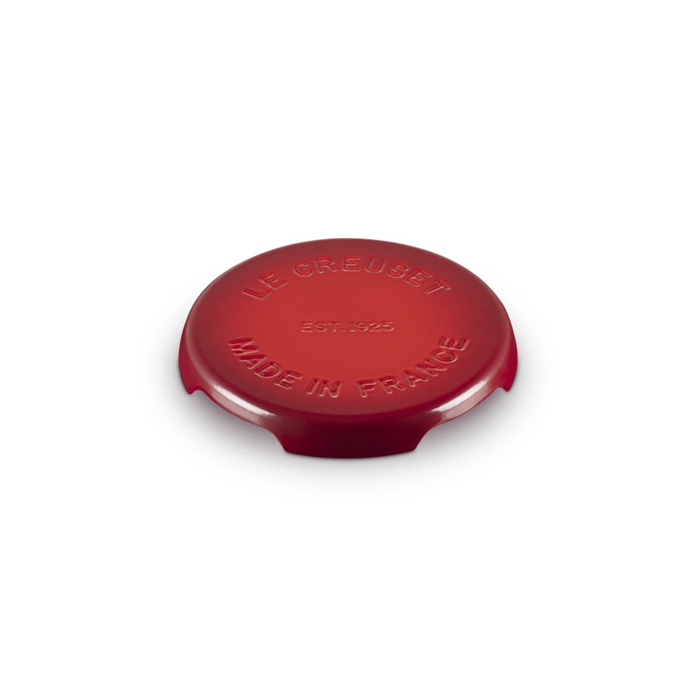 Coperchio rotondo di colore rosso, in materiale ceramico lucido, con incisioni "LE CREUSET" e "MADE IN FRANCE".