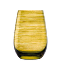 Transparent yellow glass glass with white horizontal stripe pattern on white background.