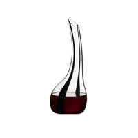 Two slender-neck glass decanters with red wine