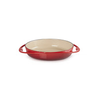 Ronde braadpan met handgrepen, colore rood esterno en afwerking beige interna. Materiale ceramico, bodem piatto.