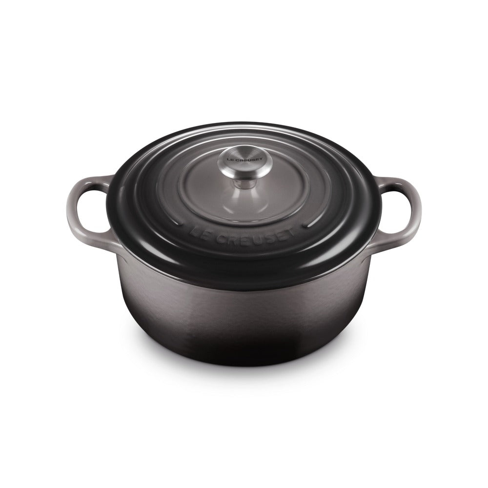 Round enamelled cast iron casserole, colour dark grey with matching lid and metal handle central.