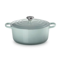 Enamelled cast iron casserole in light green, with lid and handle silver, smooth surface and edges arroundti.