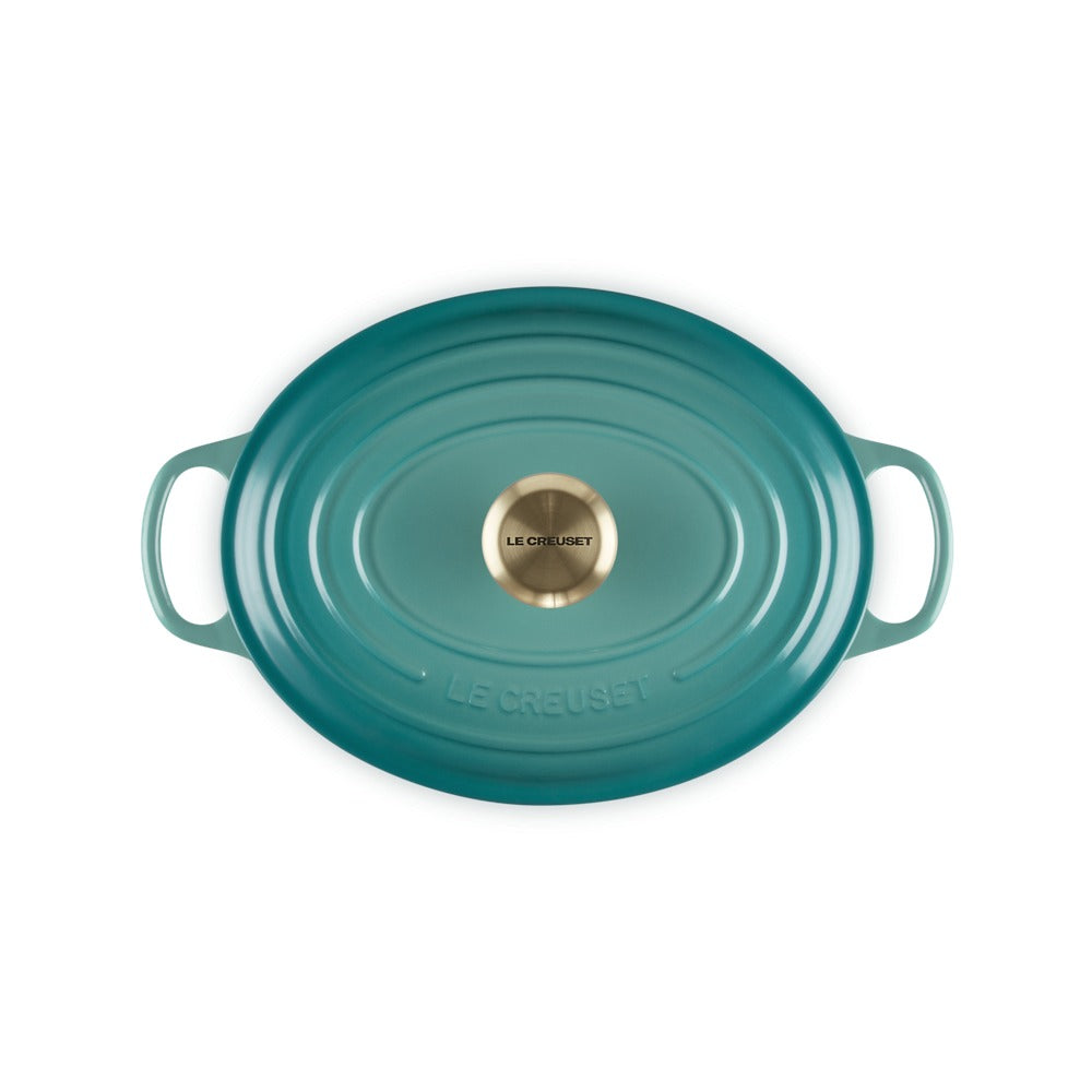 Casserole ovale en céramique bleu avec anses et couvercle, logo centrale dorato "LE CREUSET".