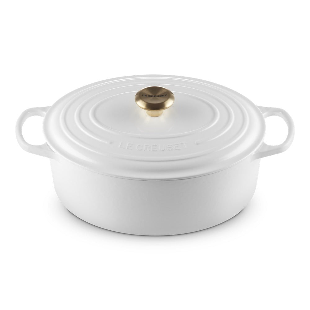 ovaal braadpan wit van keramiek met deksel, gouden handgreep en incisione sul bordo.