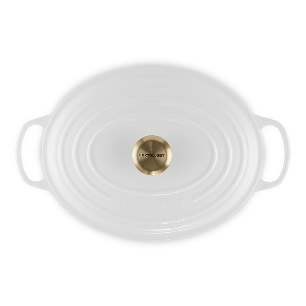 ovaal braadpan wit met handgrepen en dekselknop dorato al centro, marca zichtbaar "LE CREUSET". Sbodem wit.