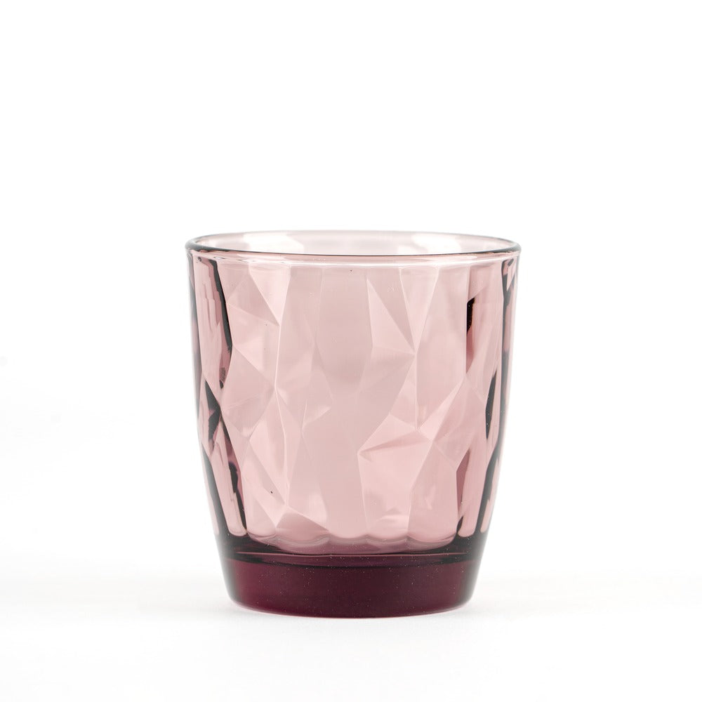 Transparent glass tumbler pink, geometric shape with reflections, dark base and smooth surface and sfaccettata.