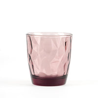 Transparent glass tumbler pink, geometric shape with reflections, dark base and smooth surface and sfaccettata.