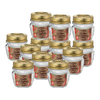 Barattoli di vetro trasparente con coperchio dorato e etichetta marrone con fragole e scritta Quattro Stagioni Rocco, su sfondo bianco.