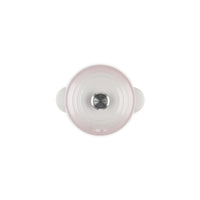 Couvercle en céramique blanc et rose avec poignées, doté d'une poignée centrale en acier inoxydable.