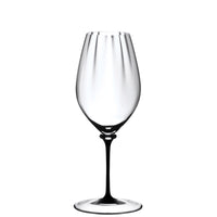 transparent wine glass in glass with elongated bowl and white round base on white background