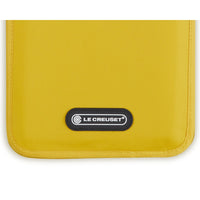 Yellow bag, textile material, with "LE CREUSET" logo in black on white background. Rectangular shape and rounded edges.