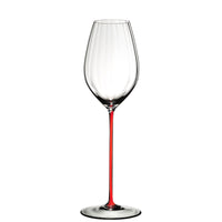 Copa de vino con pie fino rojo y copa transparente de vidrio, sobre fondo blanco.