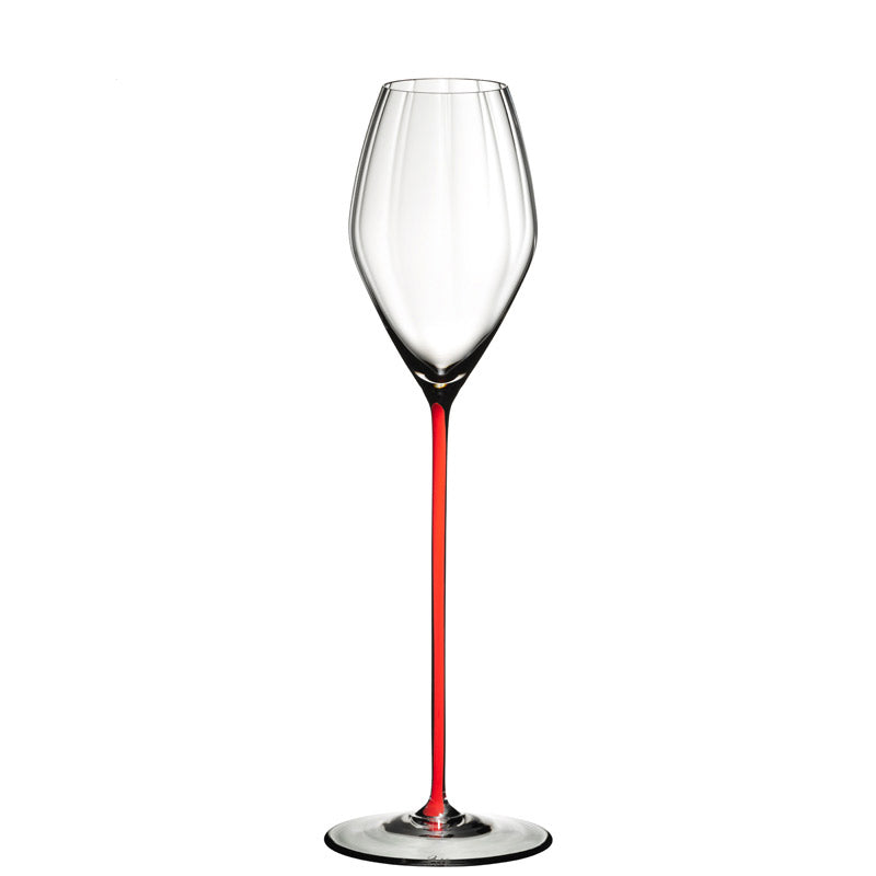 Clear wine glass with long thin red stem on white background