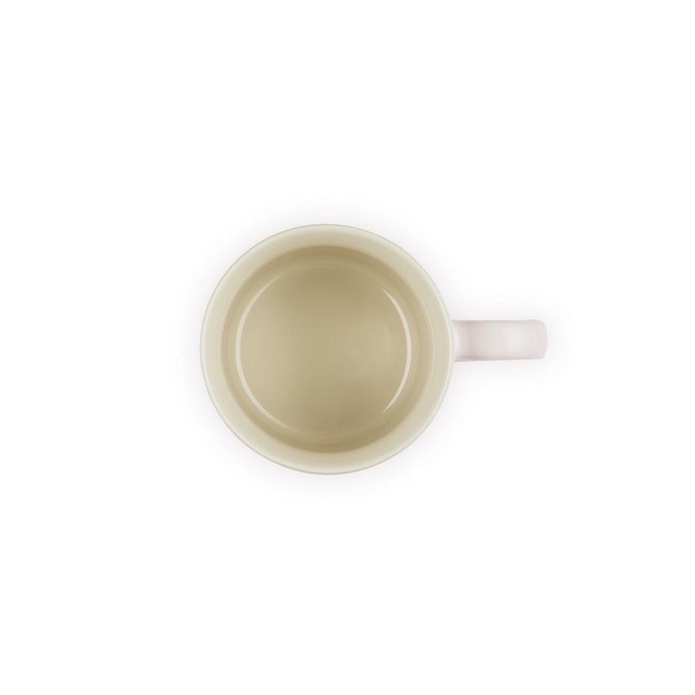 Tazza rotonda, beige con manico rosa, vista dall'alto, con interno liscio e brillante.