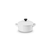 White ceramic saucepan with lid and black knob, with side handles, on white background.