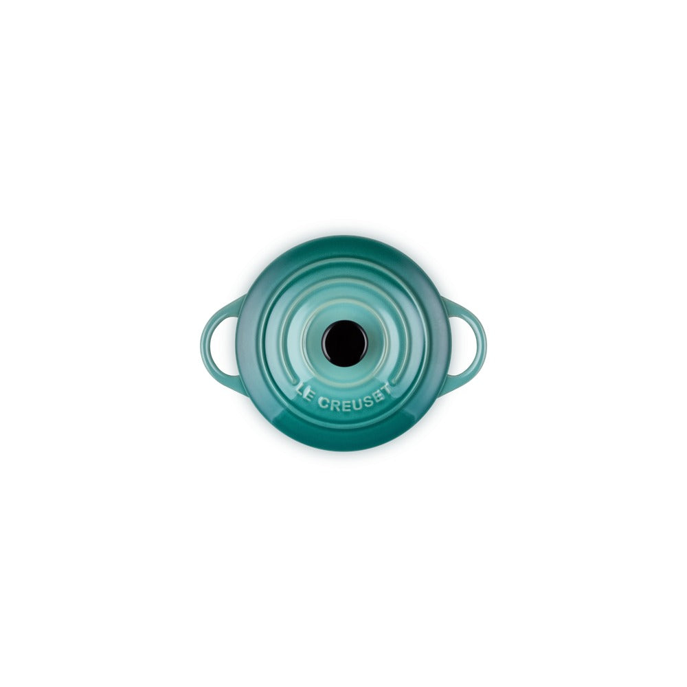 Aqua green ceramic pot lid with side handles and glossy surface, featuring a central hole.