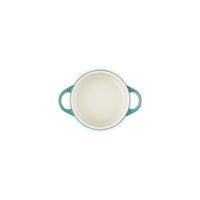 Round plate with blue rims and white inner surface, with two handles, on white background.