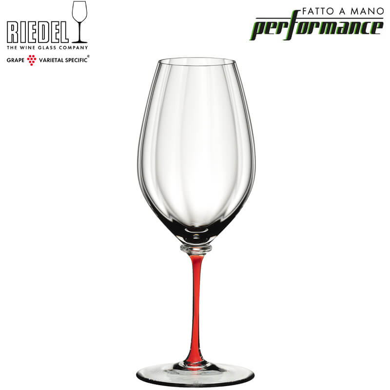 Transparent wine glass with red stem, slender shape and Riedel Performance artisan design on white background.