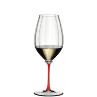 transparent glass tumbler with wide bowl, thin stem red and round base, containing white wine half full