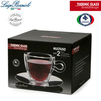 Embalaje negro que contiene set de dos tazas de vidrio térmico transparente con platillos de acero inoxidable