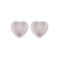 Dos cuencos en forma de corazón, en rosa claro, con acabado liso y brillante, colocados juntos sobre fondo blanco.
