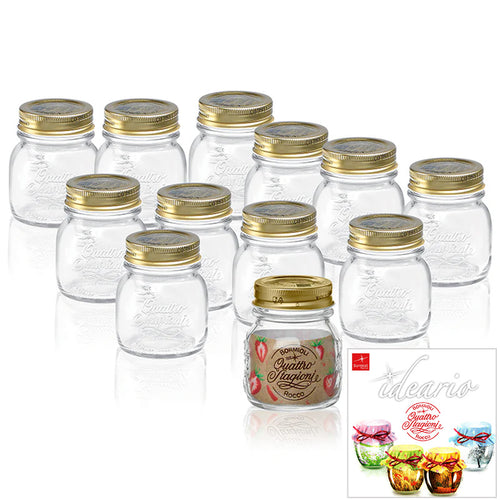 Set di 12 barattoli in vetro trasparente con coperchio dorato, uno con etichetta Quattro Stagioni e decorazioni rosse, su sfondo bianco.