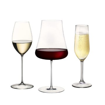 Tre calici trasparenti di vetro contenenti vino bianco, rosso e spumante, su sfondo bianco.