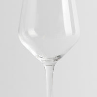 transparent wine glass in glass with bowl ampia and thin stem on light gray background