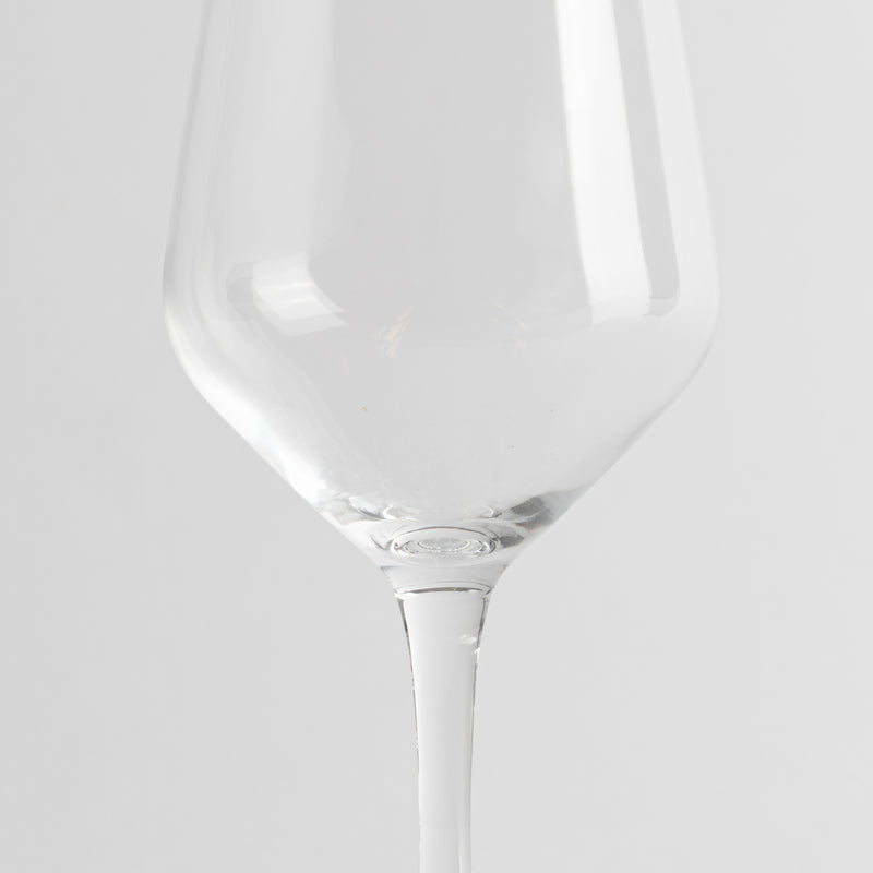 transparent wine glass in glass with bowl ampia and thin stem on light gray background