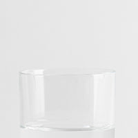 Verre transparent en verre avec forme cylindrique sur fond gris clair