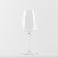 Transparent glass wine glass with conical bowl on thin stem and circular base, white background.
