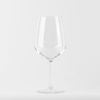 Transparent wine glass with slim stem on uniform white background