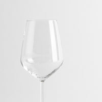 Transparent glass wine glass with thin stem on uniform white background.