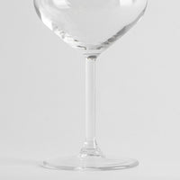 Clear glass with cylindrical stem and flat base on white background