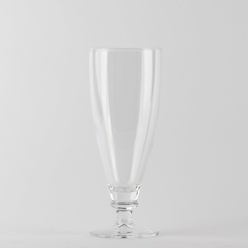 Transparent glass wine glass with elongated shape, stem and round base on white background