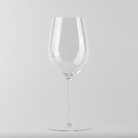 Copa de vidrio transparente con copa grande y pie delgado sobre superficie blanca con fondo gris claro
