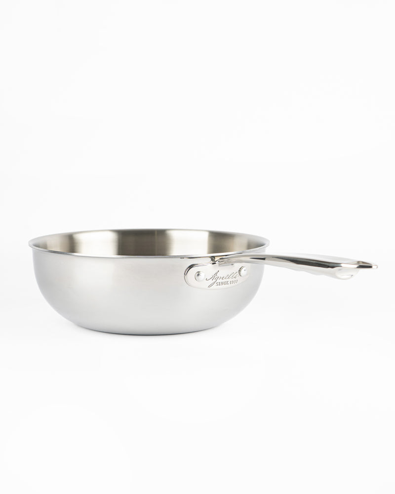 Glossy stainless steel pot, round with long handle, on white background. Engraved logo visible on side.