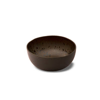 Round dark brown bowl with black speckled interior, ceramic material, on isolated white background.
