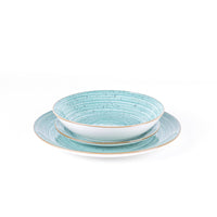 Set de platos de cerámica, color turquesa con motivos a rayas y bordes dorados, compuesto por un plato hondo y uno plano.