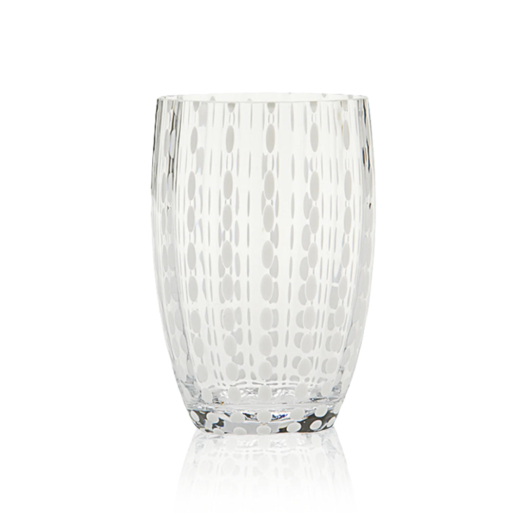 Transparent glass tumbler with opaque small pearl-shaped decorations arranged in vertical rows, white background.