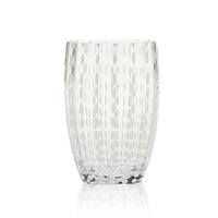 Transparent glass tumbler with opaque small pearl-shaped decorations arranged in vertical rows, white background.